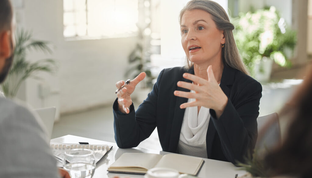Business meeting, lawyer and client, discussion and explanation of policy, legal advice and law firm. Ideas, attorney and mature woman with entrepreneur, contract and planning for trademark in office