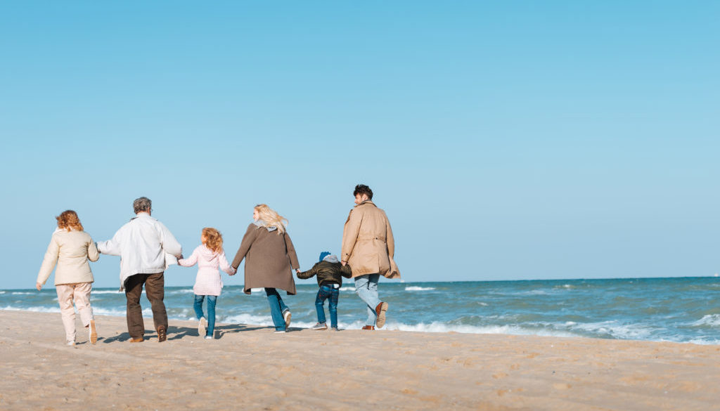 family walking at seashore