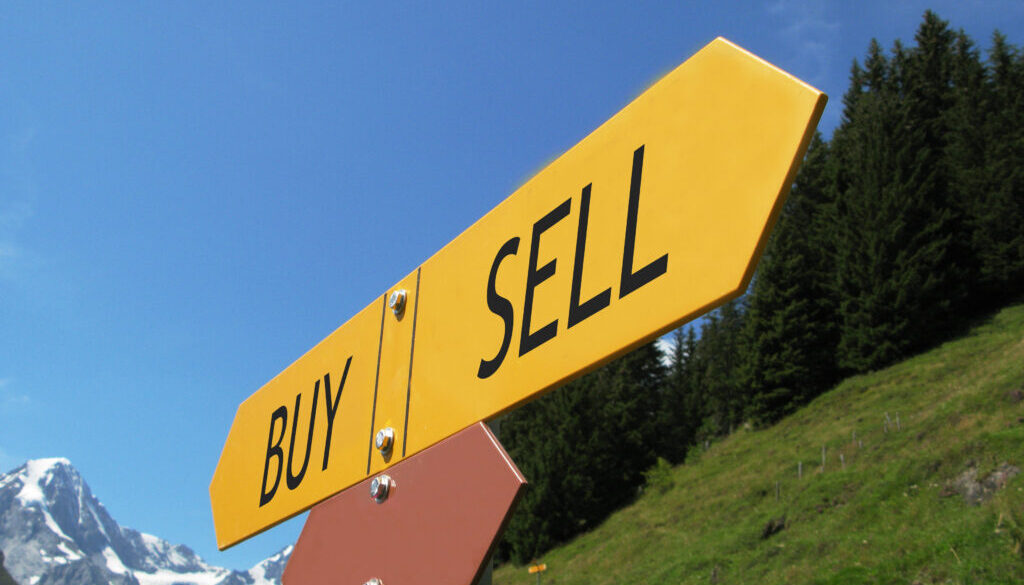 BUY-SELL sign against alpine scenery