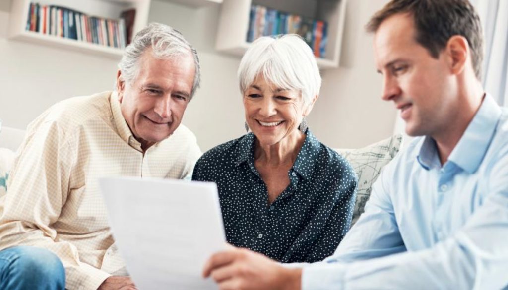 Financial advisor reviewing financial plan with elderly couple_0