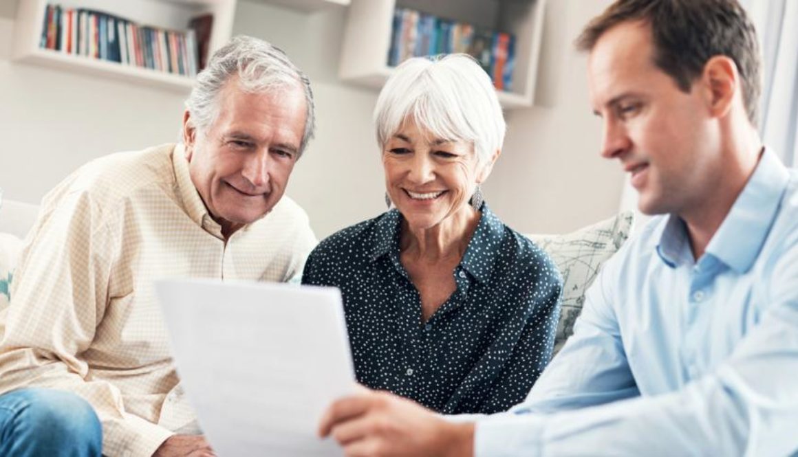 Financial advisor reviewing financial plan with elderly couple_0