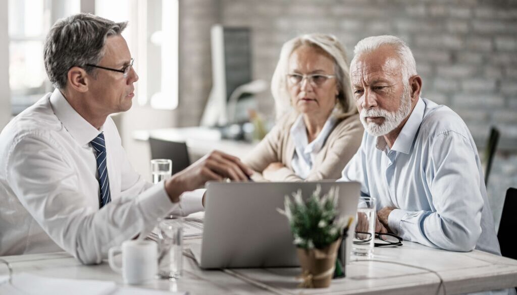 mature-couple-their-bank-manager-using-computer-while-having-consultations-office SMALL recolor 2